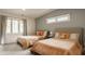 Cozy bedroom with two beds, large windows, and soft, neutral tones for a relaxing ambiance at 123 W 81St St, Indianapolis, IN 46260
