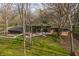 Modern home exterior with a spacious patio, outdoor seating, and large windows surrounded by lush greenery at 123 W 81St St, Indianapolis, IN 46260