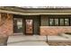 The front entrance featuring a decorative glass door with sidelight windows and brick accents at 123 W 81St St, Indianapolis, IN 46260