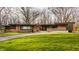 Charming single-story brick home featuring a well-maintained lawn and mature trees, offering curb appeal at 123 W 81St St, Indianapolis, IN 46260