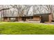 Charming single-story brick home featuring a well-maintained lawn and mature trees, offering curb appeal at 123 W 81St St, Indianapolis, IN 46260