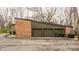 A brick two-car garage complements the house's exterior with a flat roof and brown panelling at 123 W 81St St, Indianapolis, IN 46260