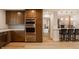 Renovated kitchen with stainless steel appliances and adjacent breakfast bar at 123 W 81St St, Indianapolis, IN 46260
