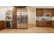 Modern kitchen with stainless steel appliances, open shelving, and wine cooler at 123 W 81St St, Indianapolis, IN 46260