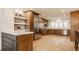 Open kitchen features stainless steel appliances, light wood floors, and ample cabinet space at 123 W 81St St, Indianapolis, IN 46260