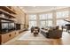 Bright living room features brick fireplace, wood floors, large windows and comfortable seating at 123 W 81St St, Indianapolis, IN 46260
