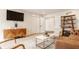 Bright living room featuring modern furniture, a large TV, and decorative shelving at 123 W 81St St, Indianapolis, IN 46260