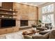Bright living room features brick fireplace, wood floors, large windows and comfortable seating at 123 W 81St St, Indianapolis, IN 46260
