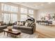 Spacious living room with wood floors, comfortable seating, large windows, and a dining area at 123 W 81St St, Indianapolis, IN 46260