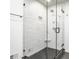 Modern bathroom featuring a glass-enclosed shower with sleek fixtures and gray tile floor at 123 W 81St St, Indianapolis, IN 46260