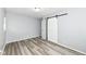 Bedroom featuring gray walls, plank flooring, and barn door closet at 1254 E 400 N, Greenfield, IN 46140