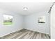 This bedroom has gray walls, plank flooring and two windows for natural light at 1254 E 400 N, Greenfield, IN 46140