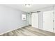 This bedroom features plank flooring, light gray walls, and barn door closet at 1254 E 400 N, Greenfield, IN 46140