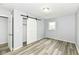Bedroom with gray walls, plank flooring, and modern closet with barn door at 1254 E 400 N, Greenfield, IN 46140