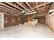 Unfinished garage with exposed beams, concrete flooring, and white walls at 1254 E 400 N, Greenfield, IN 46140