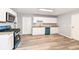Well-lit kitchen with white cabinets, modern appliances, and updated floors at 1254 E 400 N, Greenfield, IN 46140