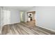 Open living room with modern floors, leading to a well-equipped kitchen with stainless appliances at 1254 E 400 N, Greenfield, IN 46140
