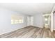 Bright living room featuring modern floors and a large window, offering ample natural light at 1254 E 400 N, Greenfield, IN 46140