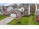 Aerial view of a two-story home with brick accents, a spacious yard, and an attached garage at 12753 Bristow Ln, Fishers, IN 46037