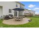 Backyard features an outdoor dining set, well-manicured lawn, and hot tub at 12753 Bristow Ln, Fishers, IN 46037