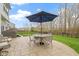 Backyard patio with large umbrella, dining set, and hot tub, great for outdoor living at 12753 Bristow Ln, Fishers, IN 46037
