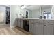 Bathroom with grey cabinets, long countertops, modern fixtures, wood floors and lots of storage at 12753 Bristow Ln, Fishers, IN 46037