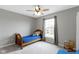 A cozy bedroom is well-lit with neutral walls, carpet, and a window with natural light at 12753 Bristow Ln, Fishers, IN 46037
