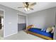 This well-lit bedroom has carpet, neutral walls, and an open closet with shelves at 12753 Bristow Ln, Fishers, IN 46037