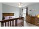 bedroom with pink accents, a wood bed frame, matching dresser and a ceiling fan at 12753 Bristow Ln, Fishers, IN 46037