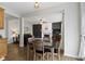 Open-concept dining room with modern light fixture and views into the living room at 12753 Bristow Ln, Fishers, IN 46037