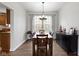 Dining area featuring a wood table, a window with backyard views, and modern light fixture at 12753 Bristow Ln, Fishers, IN 46037