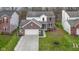 This is a front exterior view of a two-story brick home with an attached two-car garage at 12753 Bristow Ln, Fishers, IN 46037