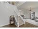 Elegant foyer with a grand staircase, stylish lighting, and warm flooring at 12753 Bristow Ln, Fishers, IN 46037