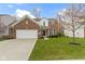 Charming brick two-story home with a well-maintained lawn and attached two car garage at 12753 Bristow Ln, Fishers, IN 46037