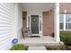 Inviting front porch with a cozy rocking chair and a welcoming wreath on the door at 12753 Bristow Ln, Fishers, IN 46037