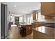 Modern kitchen with a center island, granite countertops, stainless steel appliances, and wood cabinets at 12753 Bristow Ln, Fishers, IN 46037
