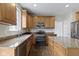 Featuring granite countertops, stainless appliances, and wood cabinetry, the kitchen is well-equipped and modern at 12753 Bristow Ln, Fishers, IN 46037
