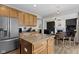 Open kitchen with granite counters, stainless appliances, and an eat-in dining area at 12753 Bristow Ln, Fishers, IN 46037