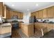 Spacious kitchen with granite counters, wood cabinets, a center island, and stainless steel appliances at 12753 Bristow Ln, Fishers, IN 46037