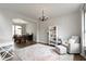 Bright living room featuring hardwood floors, a comfortable chair, and a decorative rug at 12753 Bristow Ln, Fishers, IN 46037