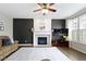 Cozy living room featuring a modern fireplace, dark accent wall, and lots of light at 12753 Bristow Ln, Fishers, IN 46037