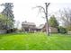 A well-maintained backyard with a lush lawn, an outdoor patio, and a charming storage shed at 13599 Brentwood Ln, Carmel, IN 46033