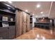 Finished basement features a rustic sliding barn door that adds warmth and character to the space at 13599 Brentwood Ln, Carmel, IN 46033