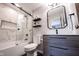 Modern bathroom featuring black hardware, stylish tile work, and a glass enclosed shower at 13599 Brentwood Ln, Carmel, IN 46033