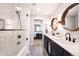 Bright bathroom showcases a double sink vanity, round mirrors, and a sleek glass shower door at 13599 Brentwood Ln, Carmel, IN 46033