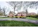 Charming two-story home with red shutters, a brick walkway and a well-manicured lawn at 13599 Brentwood Ln, Carmel, IN 46033