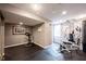A home gym featuring rubber flooring and a variety of exercise equipment, including weight machines and an exercise bike at 13599 Brentwood Ln, Carmel, IN 46033