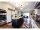 Elegant kitchen with stainless steel appliances, granite countertops, and a large island at 13599 Brentwood Ln, Carmel, IN 46033