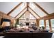 Bright living room with vaulted ceiling, skylights, stone fireplace, and comfortable seating at 13599 Brentwood Ln, Carmel, IN 46033