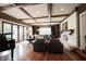 Open-concept living room with hardwood floors, a fireplace, and views of the backyard at 13599 Brentwood Ln, Carmel, IN 46033